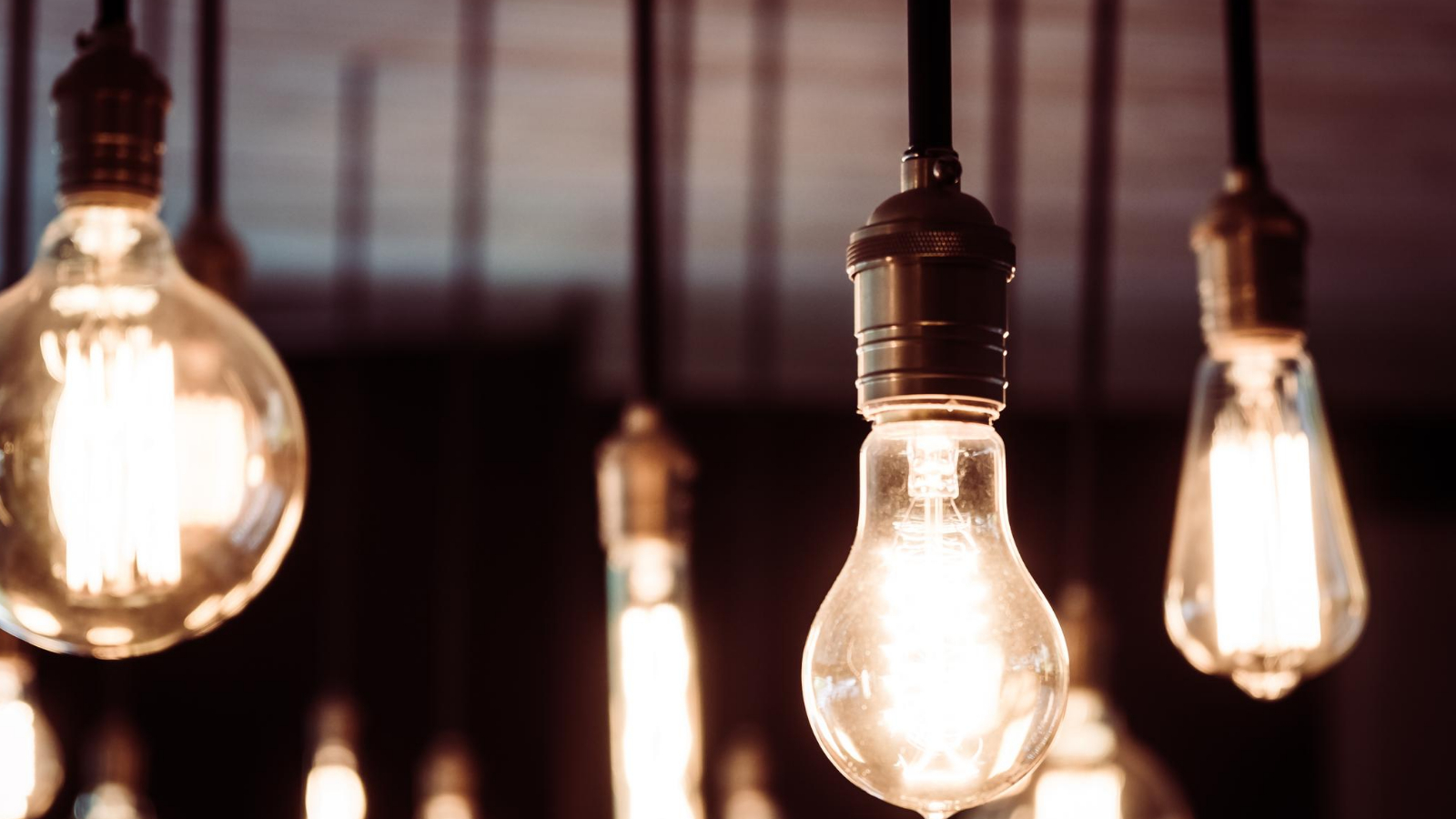 light bulbs hanging from the ceiling, connected by wires representing how sponsored posts can light up a blog
