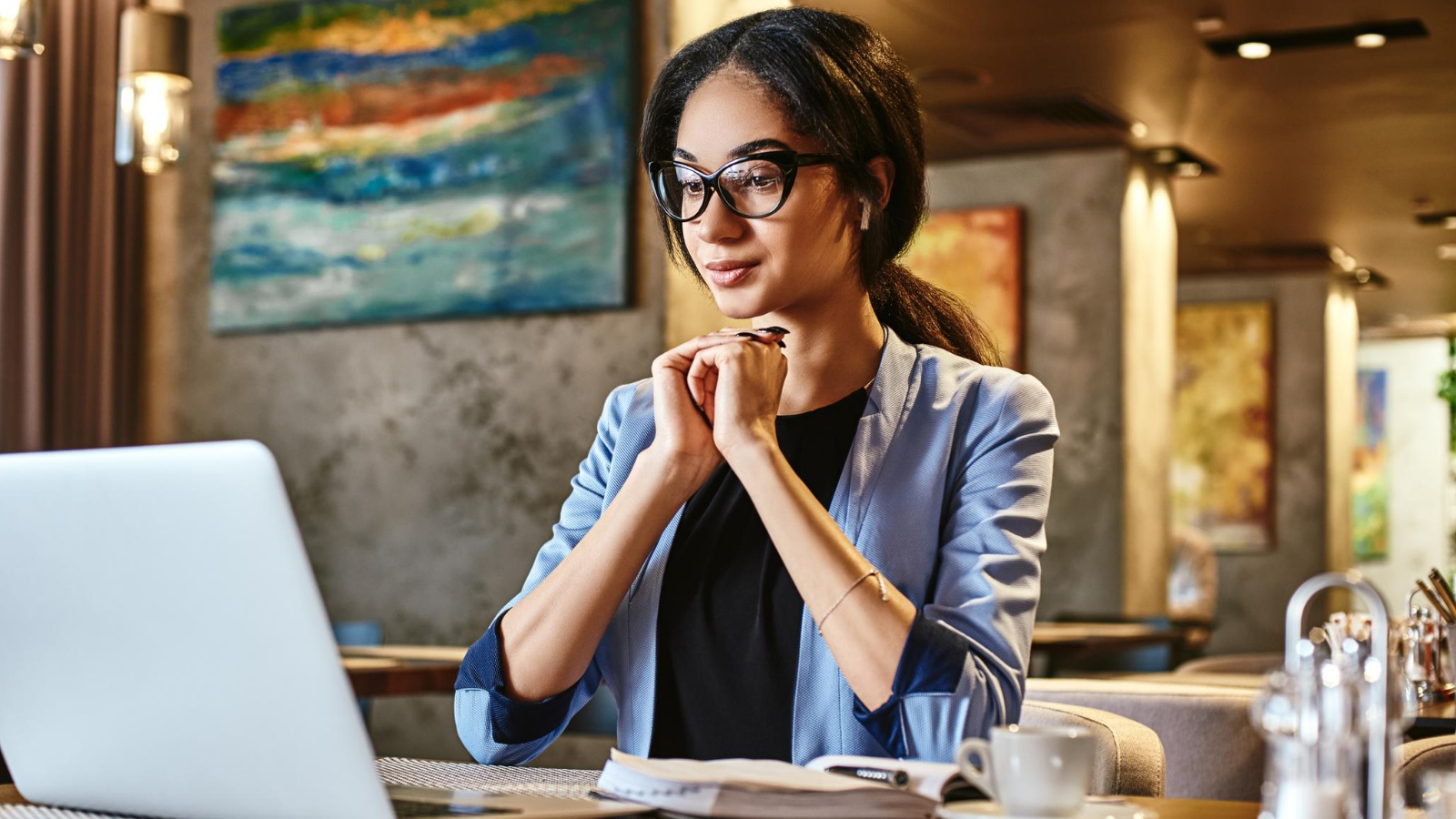 professional woman working on a laptop, providing her services online